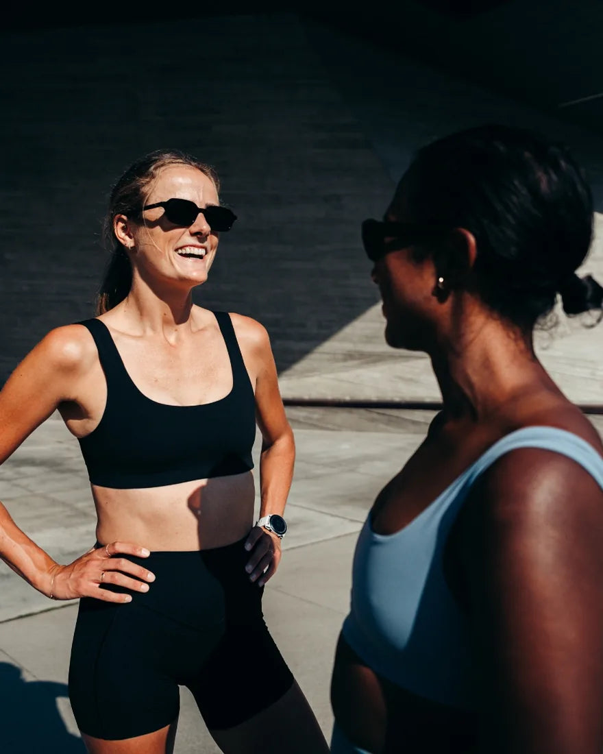 Two Hettas testers talking after a run in hard afternoon light